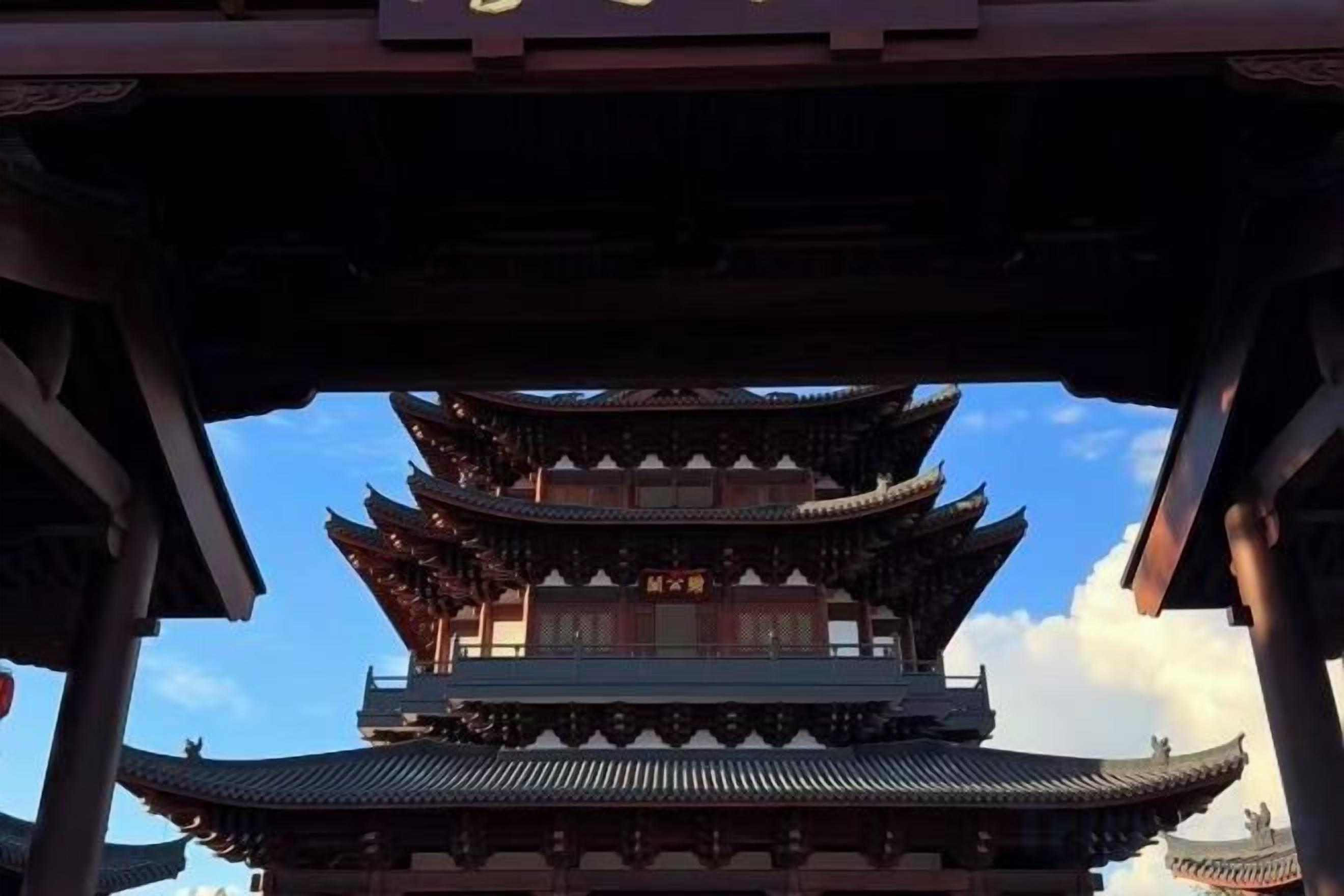 A traditional multi-tiered pagoda-style building with a clear sky in the background.