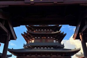 A traditional multi-tiered pagoda-style building with a clear sky in the background. - Xinyitian Hotel (Wenzhou Xueshan Road Wuma Street Branch) (Wenzhou)