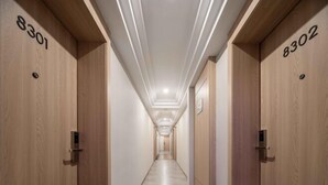 A hallway with wooden doors numbered 8301 and 8302, leading to rooms. - Xinyitian Hotel (Wenzhou Xueshan Road Wuma Street Branch) (Wenzhou)