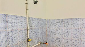 Ducha con cabezal de ducha de mano, una tubería y un grifo.