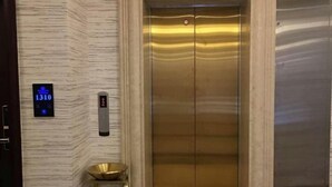 An elevator with a metallic finish, a digital display showing the number 1310, and a small digital clock. - Colorful Royal Hotel (Qingzhen Time Guizhou Ancient Town) (Qingzhen)