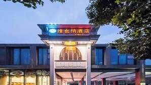 A hotel entrance with a prominent sign, a covered walkway, and parked cars. - Vienna Hotel (Suzhou Industrial Park, Yangcheng Lake, Fashion Stage) (Suzhou)