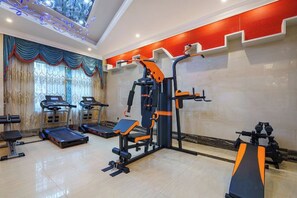 A gym with treadmills, weight machines, and a bench. - Yongkang Fengqi E-sports Hotel (Baolong Plaza) (Yongkang)
