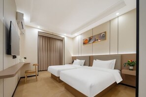 A hotel room with two beds, a TV, a desk, and a window with curtains. - Run Lai Hotel, Taihe County (Taihe)