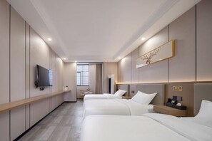 A hotel room with three beds, a TV, a bedside table, and a window with blinds. - Run Lai Hotel, Taihe County (Taihe)