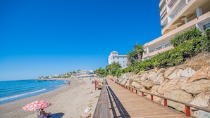 A wooden boardwalk along a beach with a clear blue sky. - Cubo's Vistalmar Calahonda Apartment / beach access / terrace / communal pool / free wifi (Mijas Costa)