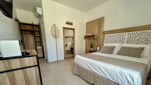 A bedroom with a bed, bedside table, and a desk with a computer. There is a wardrobe and a mirror on the wall. - "Tenuta Lu Beddhru" Oasis of peace in Salento a stone's throw from the sea  (Carpignano Salentino)