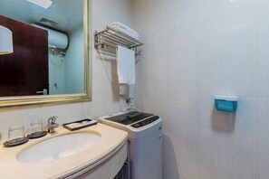 A bathroom with a sink, mirror, towel rack, and a hand dryer. - Xizhengjia Apartment (Guangzhou Pazhou Exhibition Wanshengwei Subway Station Branch) (Guangzhou)