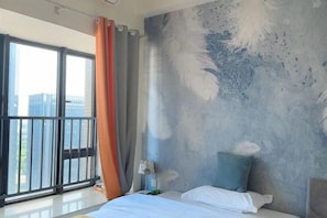 A bedroom with a large bed, a nightstand, a lamp, and a view of the city through a window. - Xizhengjia Apartment (Guangzhou Pazhou Exhibition Wanshengwei Subway Station Branch) (Guangzhou)