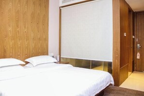 A hotel room with a wooden wall, a large bed with white bedding, a window with a blind, and a wooden door. - WENZHOU JIAYAN HOTEL (Wenzhou)