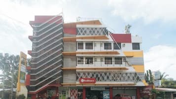 A multi-story building with a commercial ground floor, including a visible storefront with signage.