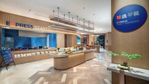 A modern breakfast area with a buffet setup, a sign for Express Start™, and a sign for Express Breakfast.