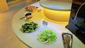 A buffet setup with various dishes including salads and a tray of eggs. - Piaohome Chain Hotel (Beijing Guomao Dawang Road Subway Station Store) (Beijing)