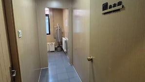 A narrow hallway with a door on the right labeled "Guest Room." - Piaohome Chain Hotel (Beijing Guomao Dawang Road Subway Station Store) (Beijing)