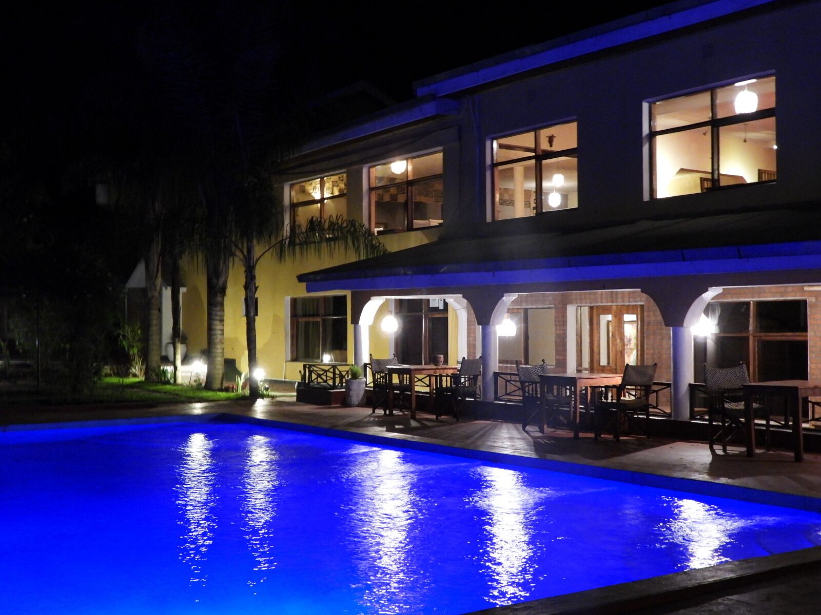 A two-story building with a swimming pool in front.