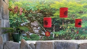 A mural with a stone wall and a potted plant. - Shexia Li Yu (Pingtung)