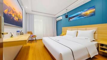 A hotel room with a large bed, a desk, and a chair. There is a painting on the wall and a window with curtains.