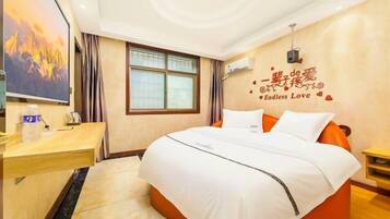 A hotel room with a bed, a desk, a chair, a window, and a wall decoration.