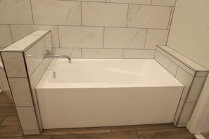 Separate bathtub and shower, hair dryer, towels, soap