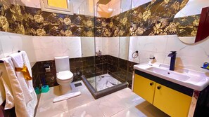 A bathroom with a toilet, sink, and shower area. - Nemes Pyramids View Inn (Giza)