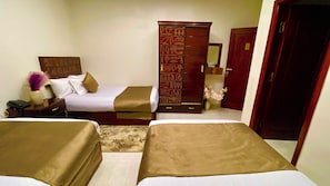 A hotel room with two beds, a wooden wardrobe, a nightstand, and a mirror. - Nemes Pyramids View Inn (Giza)