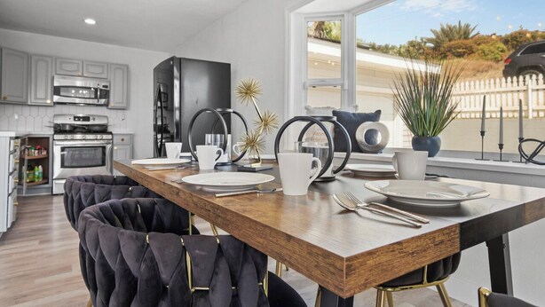A modern kitchen with a wooden island, stainless steel appliances, and a large window offering a view of the outdoors. - 5bed/3ba, Gameroom, Pool, Spa, Sleeps 20+, Views (San Diego)