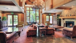 A spacious lobby with a fireplace, comfortable seating, and large windows offering a view of the outdoors. - Mountain Thunder Lodge 2 Bedroom Condo - Ski In via Skyway Skiway! (Breckenridge)