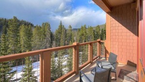 A balcony with a view of a forested mountain range. - Mountain Thunder Lodge 2 Bedroom Condo - Ski In via Skyway Skiway! (Breckenridge)