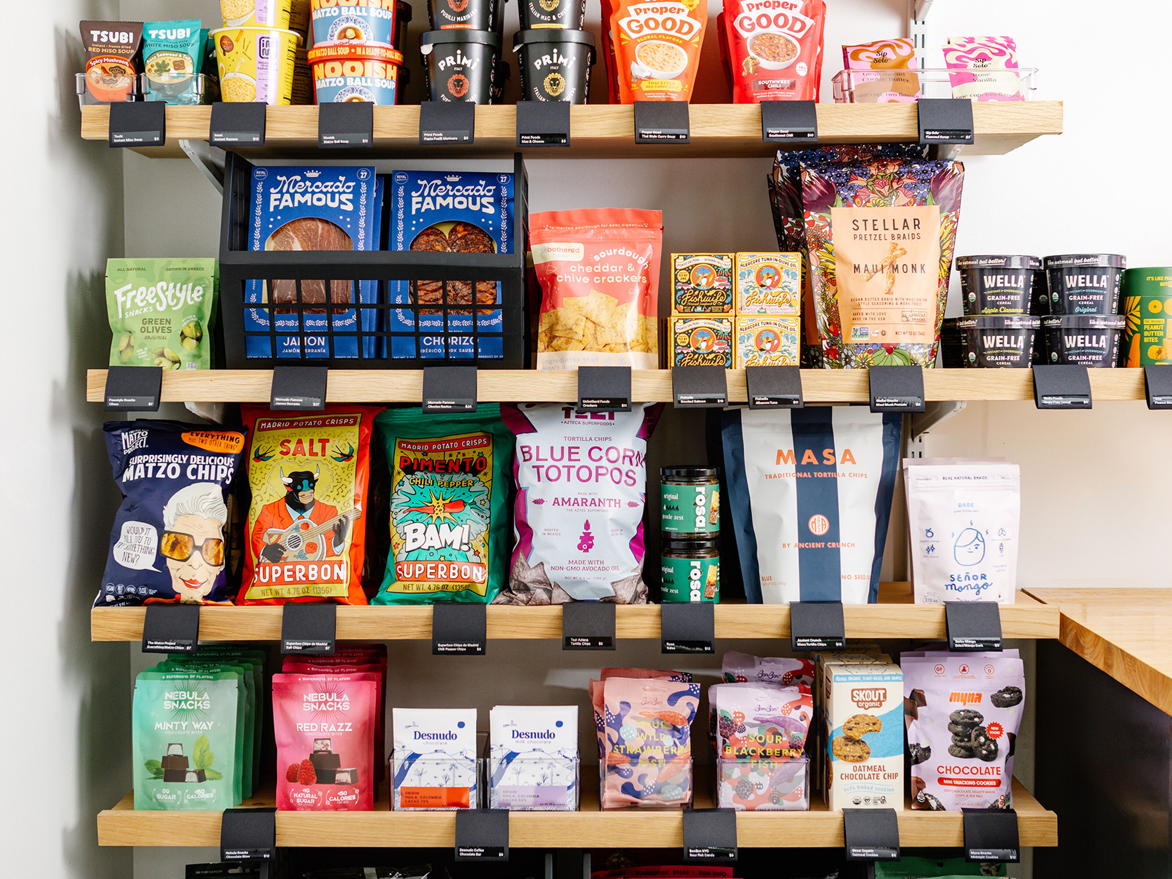 A variety of snack and food products displayed on shelves in a store.