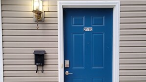 A blue door with the number 311C, a mailbox, and a wall-mounted light fixture. - RiverTown Retro | King Bed | Near Deaconess | Pet-Friendly (Newburgh)