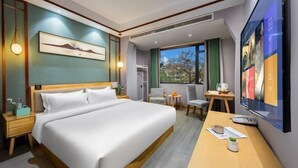 A hotel room with a large bed, a desk, a chair, a TV, and a window with a view. - Chenyue Hotel (Chengdu Southwest University of Finance and Economics Subway Station) (Chengdu)
