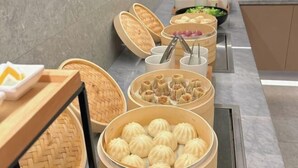 A buffet setup with various food items, including dumplings and vegetables, arranged on a counter. - Chenyue Hotel (Chengdu Southwest University of Finance and Economics Subway Station) (Chengdu)