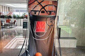 A basketball hoop with a net, a basketball, and a wall with a geometric pattern. - Chenyue Hotel (Chengdu Southwest University of Finance and Economics Subway Station) (Chengdu)