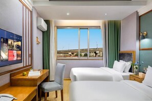 A hotel room with a bed, a desk, a chair, a TV, and a window with a view of buildings. - Chenyue Hotel (Chengdu Southwest University of Finance and Economics Subway Station) (Chengdu)