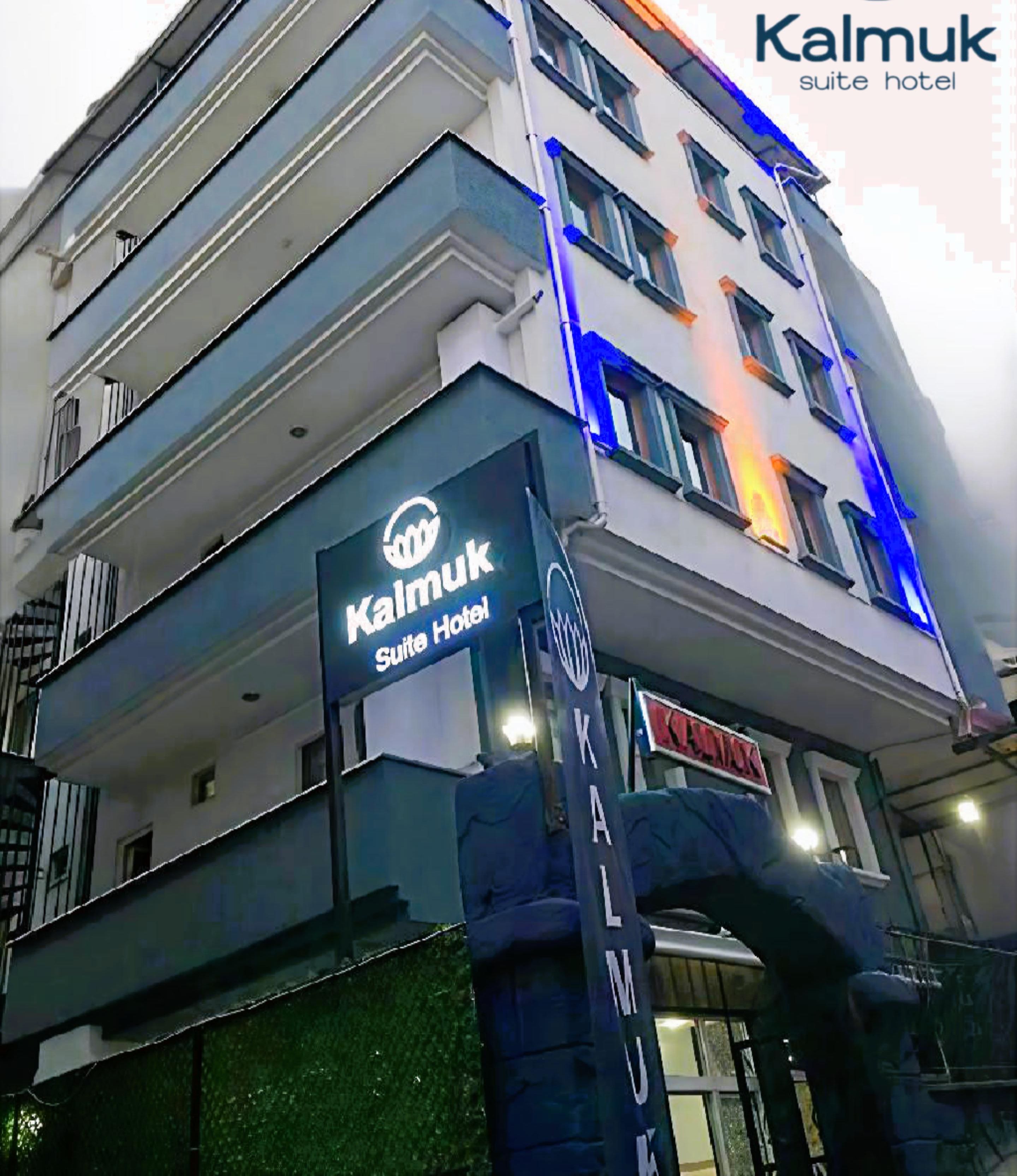 A multi-story building with the sign "Kalmuk Suite Hotel" indicating it is a hotel.
