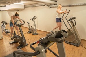A gym with multiple stationary bikes and treadmills.
