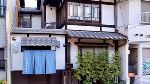 Een traditioneel Japans gebouw met pannendak, houten balken en een klein balkon.