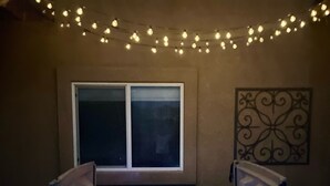 A hot tub in a room with a window and string lights. - Entire home in Palmer Lake, CO (Palmer Lake)