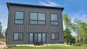 A modern two-story building with large windows and a flat roof.