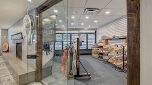 A modern interior of a market with glass doors, a clothing rack, and baskets of goods. - Comfortable 3-bedroom Ski In/out Condo at Peak 9 - Village at Breckenridge (Breckenridge)