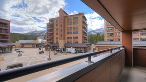 A hotel with multiple floors, outdoor seating areas, and a mountain view. - Comfortable 3-bedroom Ski In/out Condo at Peak 9 - Village at Breckenridge (Breckenridge)