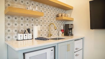 Fridge, microwave, coffee/tea maker, cookware/dishes/utensils