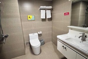 A bathroom with a toilet, sink, and shower. - Golden Times Holiday Hotel (Huoshan)
