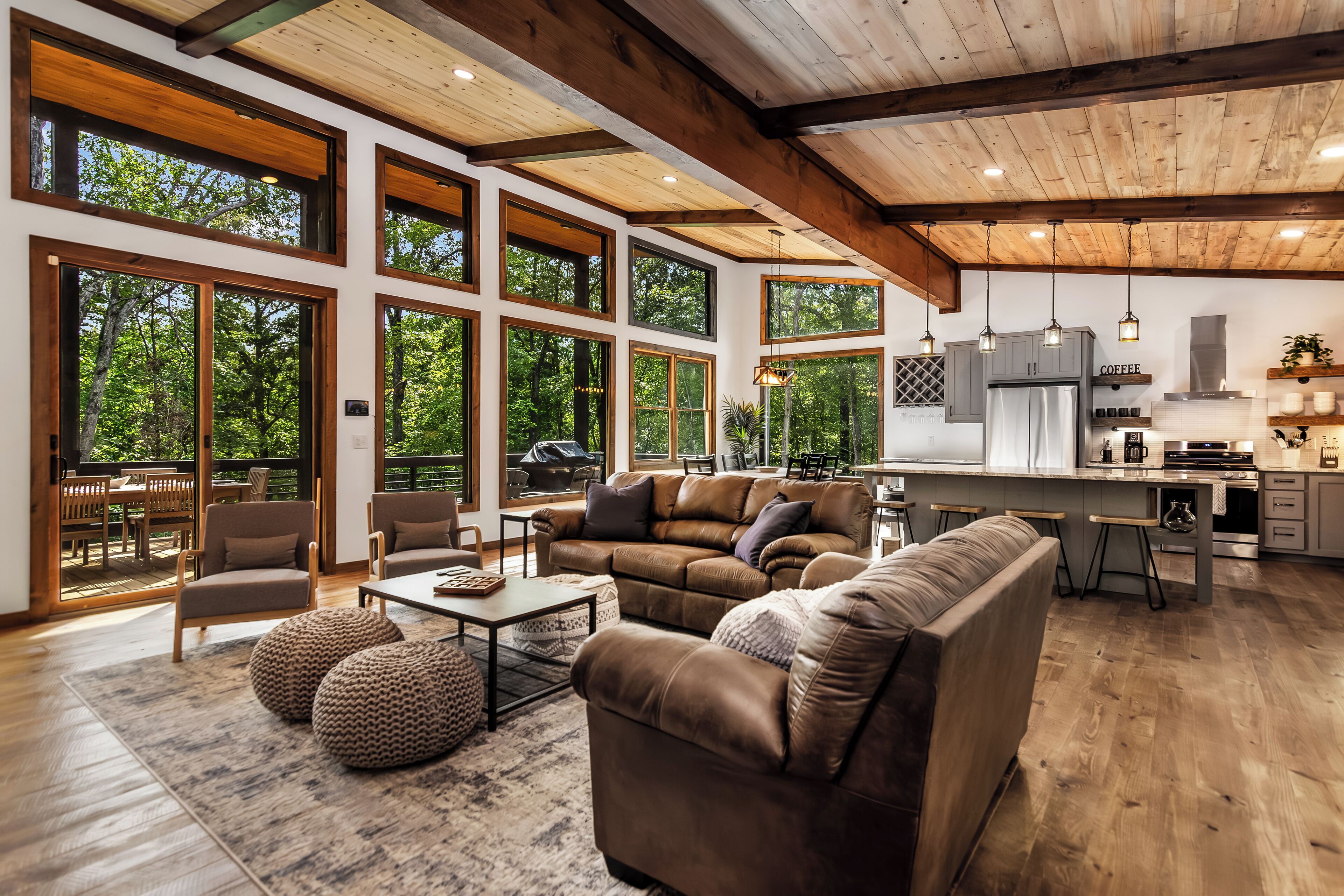A cozy living room with sofas, armchair, and a coffee table with natural light.