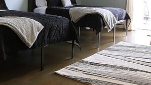 A room with two beds, a large window, and an air conditioning unit. - Our 2nd Studio at The Lofts in Hesperia.
 (Hesperia)
