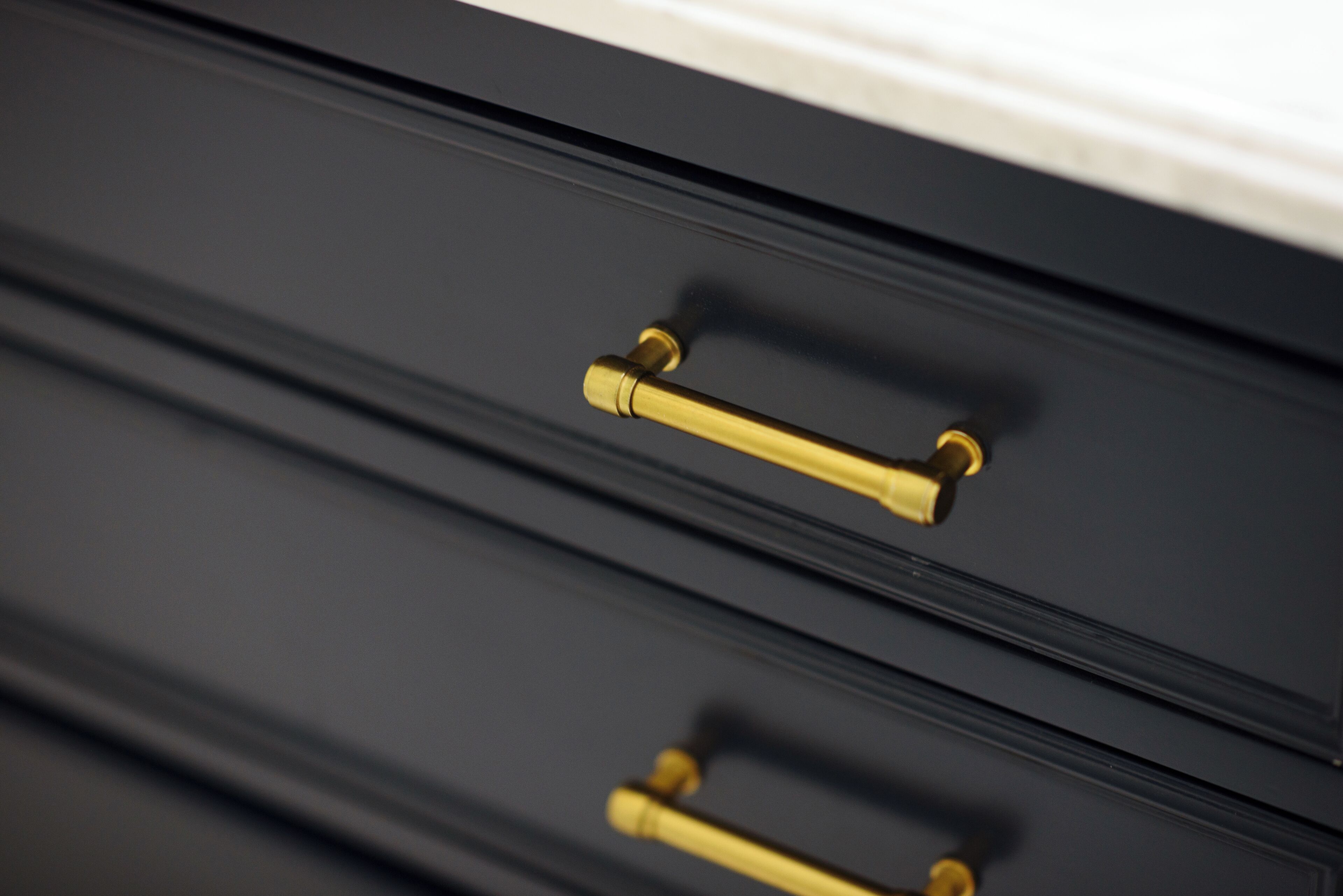 A close-up of a drawer with a brass handle.