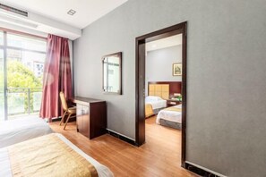 A hotel room with a bed, desk, chair, and a view of the outside. - Xinyu Holiday Hotel (Huangshan Tunxi) (Huangshan City)