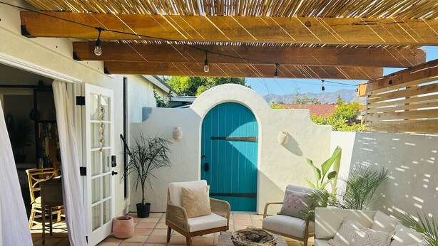 An outdoor patio with wicker furniture, a blue door, and potted plants. - Ojai Serenity Retreat - Tranquil Valley Escape (Ojai)