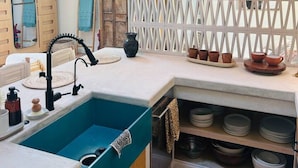 A kitchen with a blue sink, wooden cabinets, a white countertop, and two hanging wicker lamps. - Ojai Serenity Retreat - Tranquil Valley Escape (Ojai)