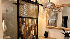 A bathroom with a glass partition, a wooden desk, a chair, a hanging light fixture, and a mirror. - Ojai Serenity Retreat - Tranquil Valley Escape (Ojai)